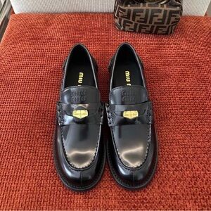 Miu Miu Black Loafers with Gold Detail